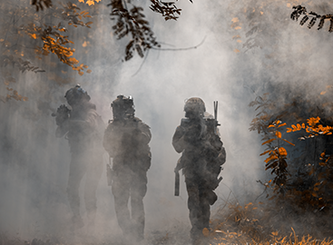 soldiers on patrol with smoke background